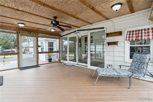 unfurnished sunroom featuring wood ceiling and ceiling fan