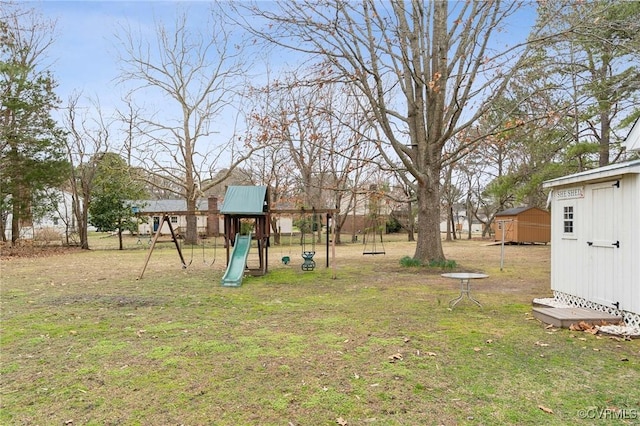 view of yard featuring an outbuilding, a shed, and a playground