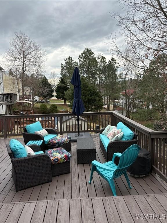 wooden deck with an outdoor living space