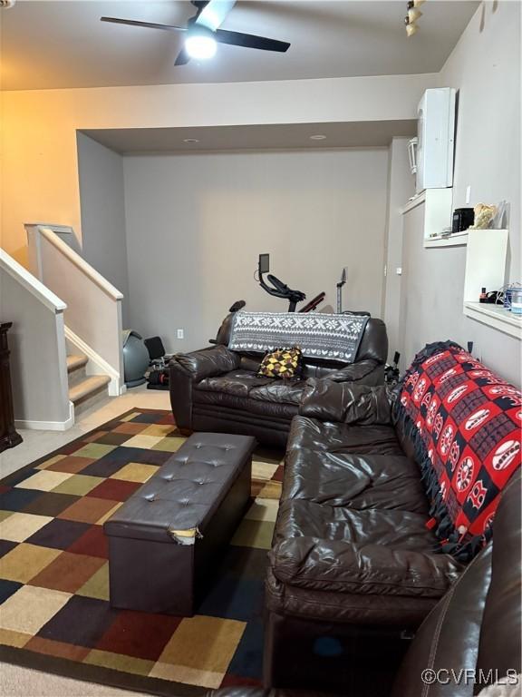 living area with stairway and ceiling fan