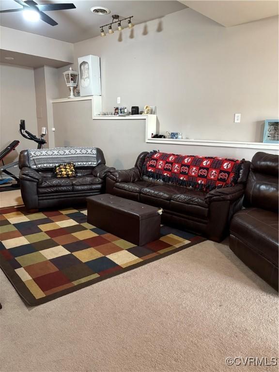 living area featuring rail lighting, visible vents, carpet, and a ceiling fan