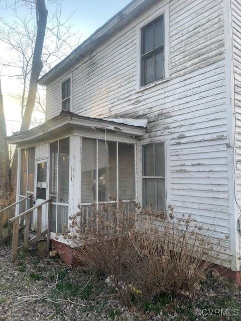 view of home's exterior featuring a sunroom