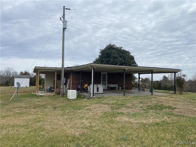 back of house featuring a patio area and a yard