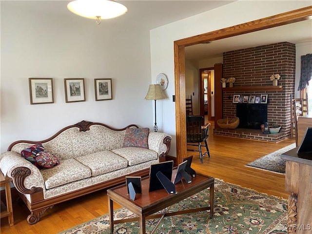 living room featuring wood finished floors and a fireplace