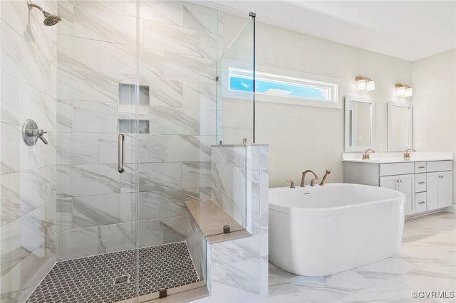 full bath with marble finish floor, a stall shower, a freestanding bath, and vanity