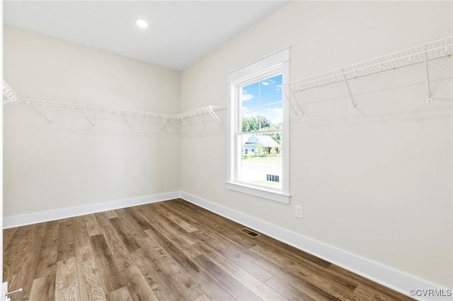 spacious closet with wood finished floors and visible vents