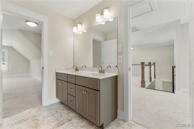 bathroom with a sink, visible vents, baseboards, and double vanity