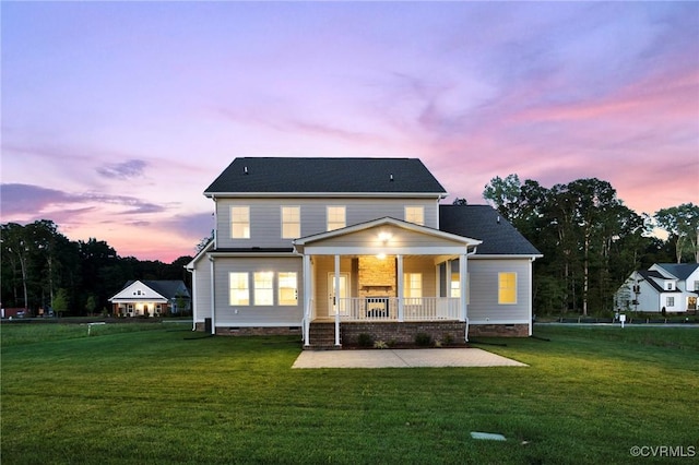 view of front facade featuring crawl space, a lawn, and covered porch