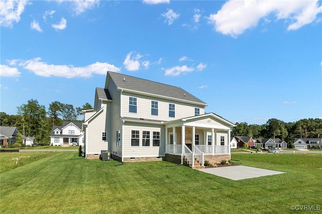 rear view of property featuring crawl space, central air condition unit, a lawn, and a porch