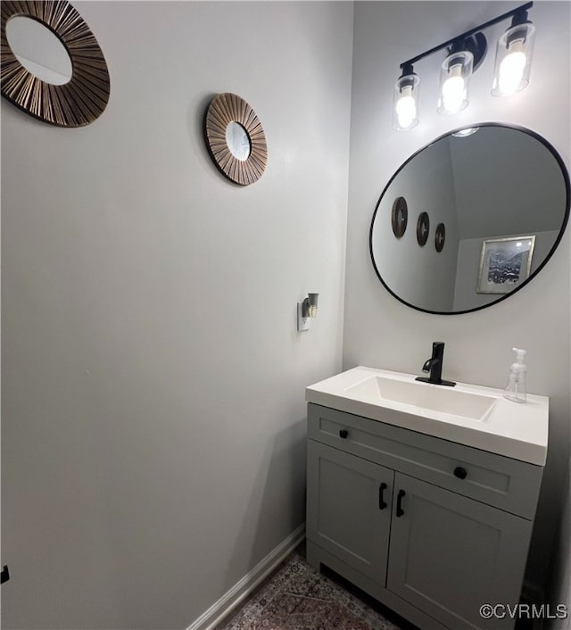 bathroom with vanity and baseboards