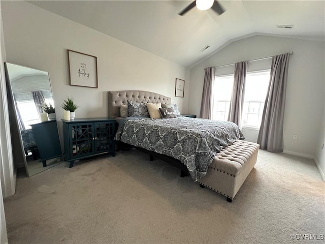 carpeted bedroom featuring visible vents, lofted ceiling, baseboards, and ceiling fan