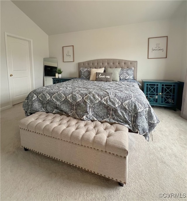 bedroom with vaulted ceiling and carpet