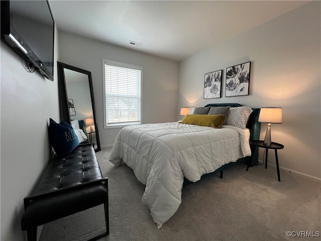 bedroom featuring visible vents, carpet, and baseboards