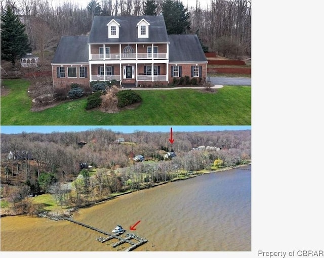 view of front of property featuring a water view, covered porch, and a front yard