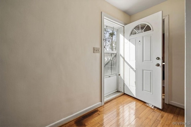 foyer entrance with light wood-type flooring and baseboards