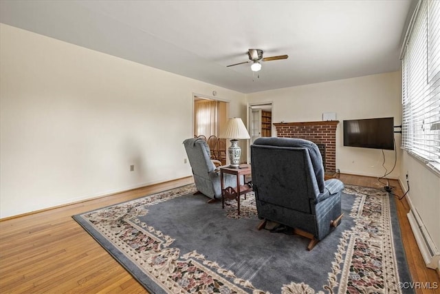 sitting room with a ceiling fan and wood finished floors