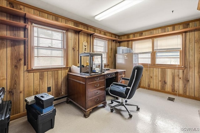 home office featuring a baseboard heating unit, a healthy amount of sunlight, and visible vents