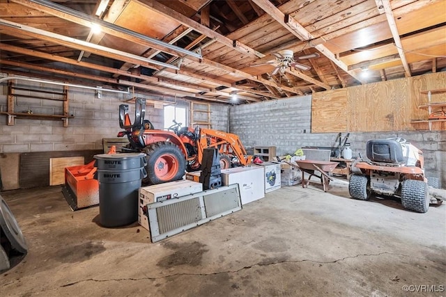 below grade area featuring a garage and concrete block wall