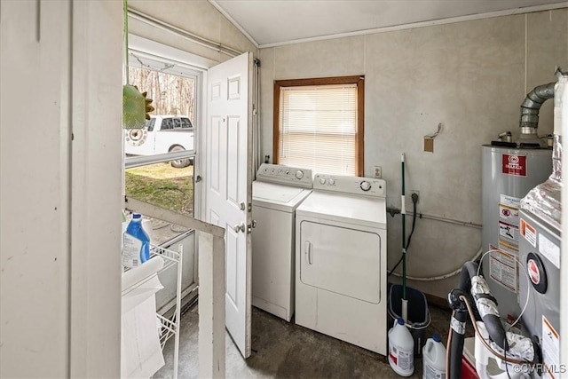 clothes washing area featuring gas water heater, a wealth of natural light, laundry area, and washing machine and clothes dryer