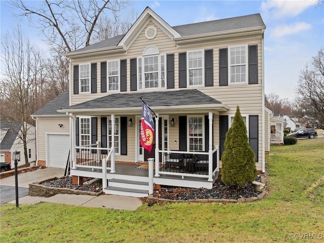 view of front facade featuring a porch, a front yard, and driveway