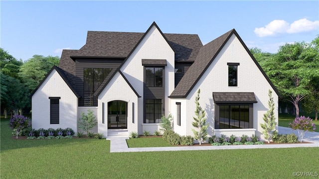 view of front of property featuring brick siding, a front yard, and a shingled roof