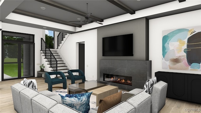 living area with light wood-type flooring, beamed ceiling, stairs, and a tile fireplace