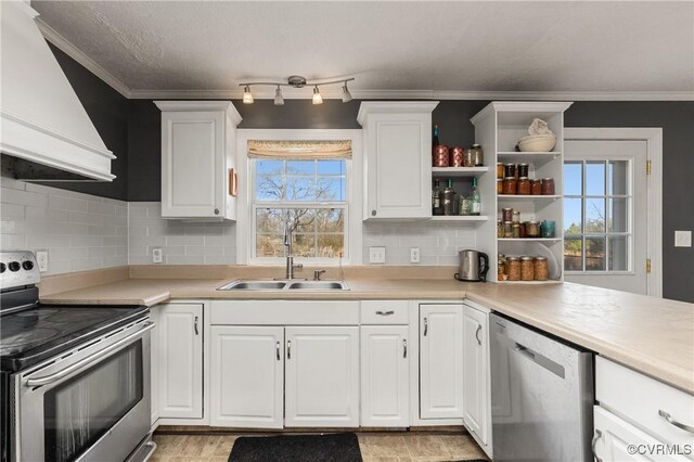 kitchen featuring a sink, stainless steel appliances, light countertops, and custom range hood