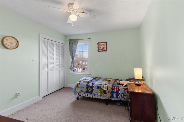 bedroom featuring a closet, baseboards, and carpet floors