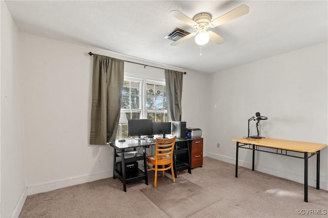 carpeted office with visible vents, baseboards, and ceiling fan