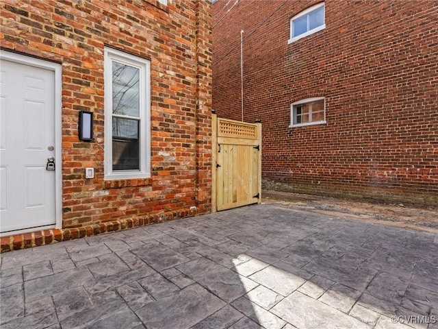 view of exterior entry featuring brick siding