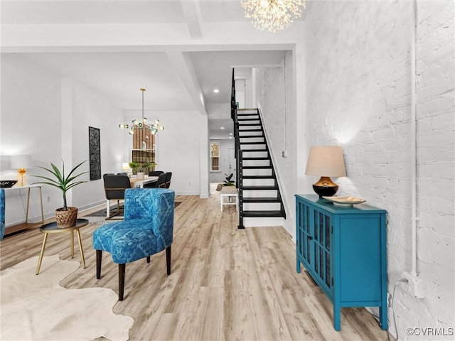 interior space with baseboards, stairway, beamed ceiling, light wood-style flooring, and a notable chandelier