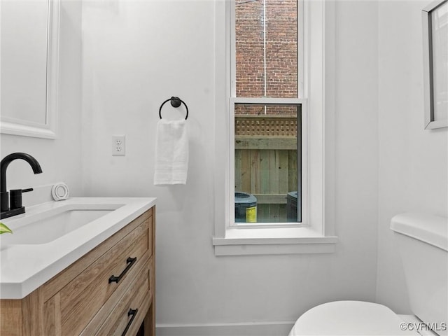 bathroom with toilet and vanity