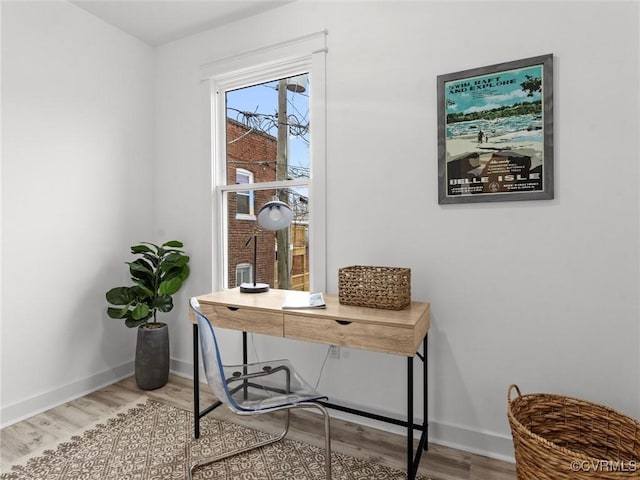 office area featuring baseboards and wood finished floors