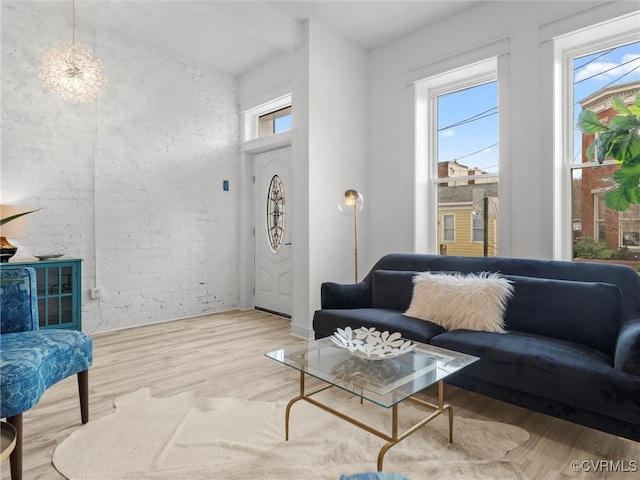 living room with brick wall and wood finished floors