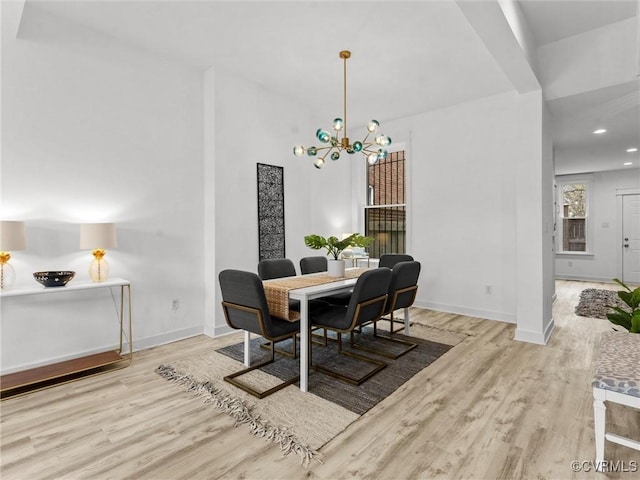 dining room with recessed lighting, a notable chandelier, wood finished floors, and baseboards