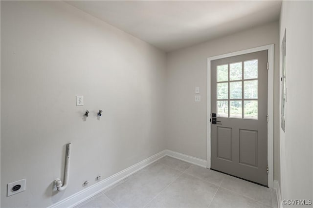 entryway with light tile patterned floors and baseboards