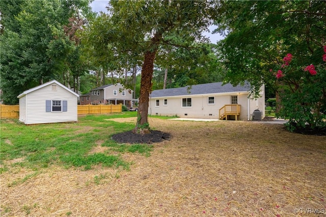 view of yard with an outdoor structure and fence