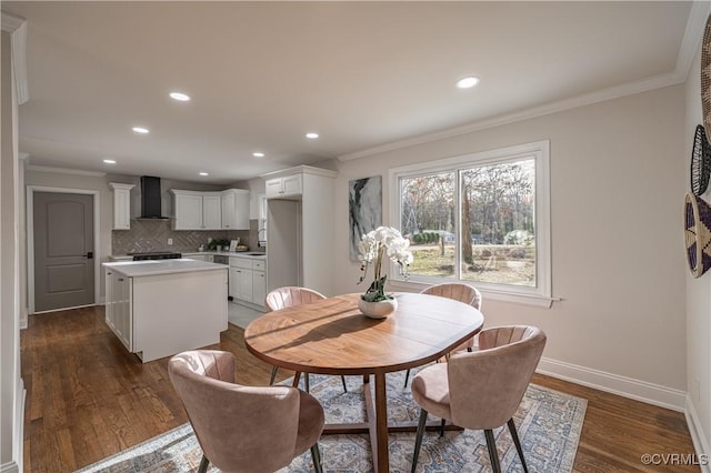 dining space with dark wood-style floors, baseboards, and ornamental molding