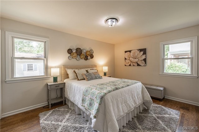 bedroom with wood finished floors and baseboards