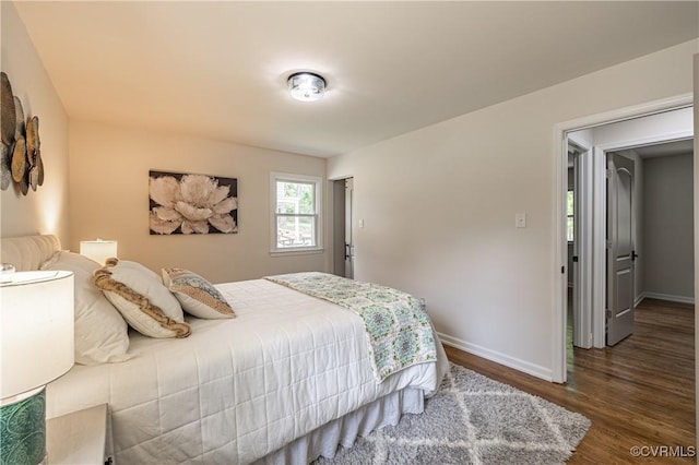 bedroom with wood finished floors and baseboards