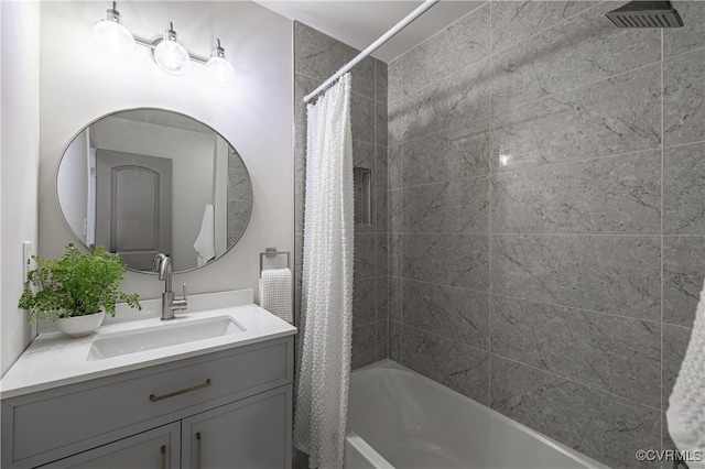 full bath featuring visible vents, vanity, and shower / bath combo