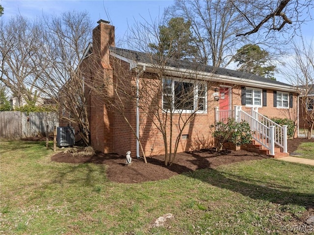 ranch-style house with brick siding, fence, a front yard, a chimney, and crawl space