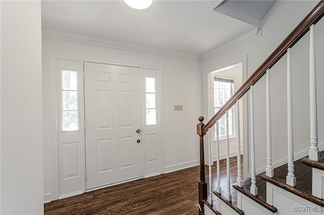 entryway with stairs, dark wood-style floors, baseboards, and ornamental molding