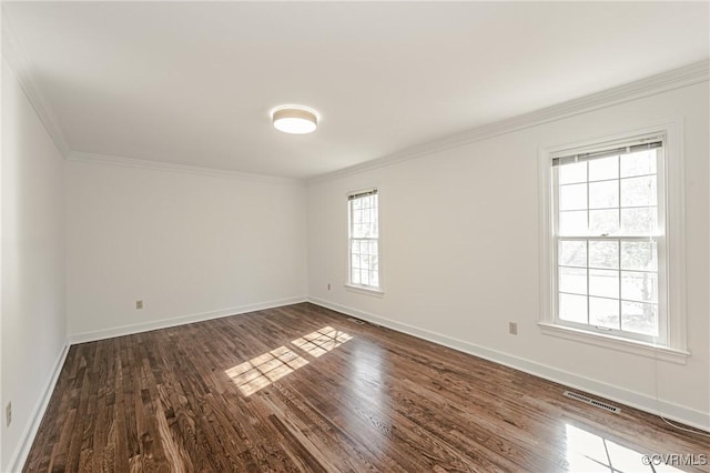 unfurnished room with visible vents, baseboards, dark wood-type flooring, and ornamental molding