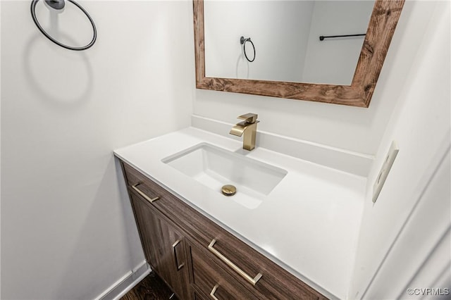 bathroom featuring baseboards and vanity