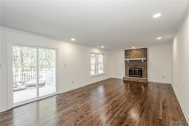 unfurnished living room with recessed lighting, dark wood-type flooring, ornamental molding, and a fireplace