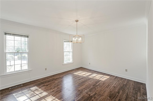 empty room with dark wood-style floors, baseboards, and ornamental molding