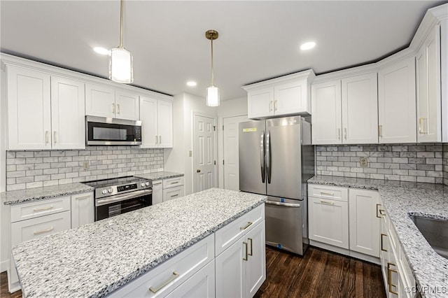 kitchen with white cabinetry, dark wood-style floors, tasteful backsplash, and stainless steel appliances