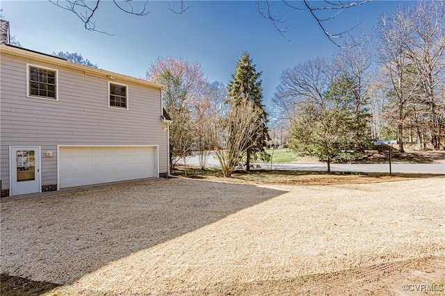 view of side of property featuring a garage and driveway