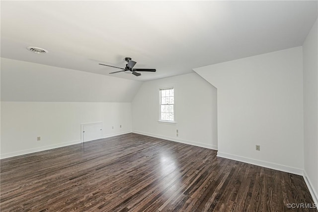 bonus room with visible vents, lofted ceiling, a ceiling fan, dark wood finished floors, and baseboards